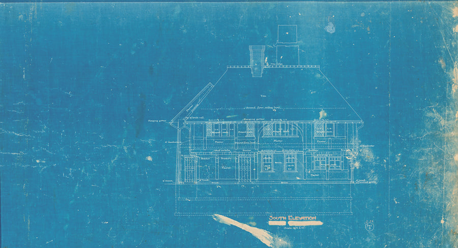 A historic architectural blueprint of our pottery building is printed on blue paper.
