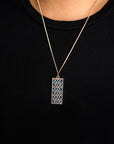 Necklace with a rectangular pendant on a black background