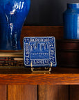 Decorative Old Detroit tiles in glossy Lake Superior glaze on a handcrafted Stickley cabinet next to two vases in bright-blue Ultramarine.