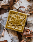 The tile features a large maple leaf with delicate veins reaching out the the tips of its ends. This tile has a simple square border.