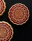 Three Mooncake Paperweights in two-tone Scarlet/Honey.