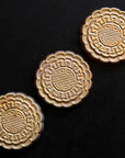 Three Mooncake Paperweights in shimmering Blush Iridescent.