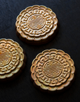 Three Mooncake Paperweights in shimmering Blush Iridescent.