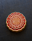 A Mooncake Paperweight in two-tone Scarlet/Honey.
