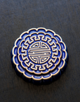 A Mooncake Paperweight in two-tone Lapis/Scrape.