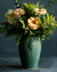 This Pinecone Vase features the semi-matte variable green Elm glaze.
