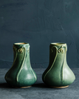 Elm-glazed Snowdrop Vase with snowdrop flower carvings on a dark, textured background and slate foreground.