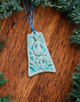 The ornament is glazed in a matte pale blue color.
