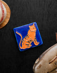 Hand-painted 3x3 Tigers tile on a dark wood surface with a baseball and glove.