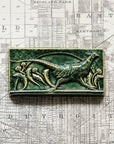 This hand-sculpted tile features a pheasant running through a field of dandelions. It is featured in a glossy green Kale glaze.