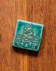 This tile features the matte turquoise Pewabic Blue glaze.