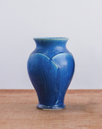 The Peacock glaze is a matte french blue color.