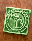 This Beauty and Bounty of Michigan tile is featured in the matte deep green Leaf glaze.