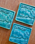  This Detroit Skyline Tile features the matte turquoise Pewabic Blue glaze.