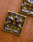 This Maple Leaf Tile features the glossy earthy brown Molasses glaze.