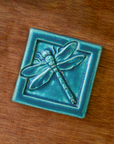 This Dragonfly Tile features the matte turquoise Pewabic Blue glaze.