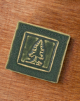 This tile features the matte dark mossy green Bayleaf glaze.