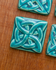 This Lover's Knot features the matte turquoise Pewabic Blue glaze.