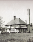 A historic black and white image of the pottery building.