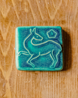 This tile features the matte turquoise Pewabic Blue glaze.