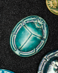 A Pewabic Blue Scarab Paperweight.