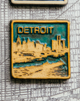 This two-tone Detroit Skyline tile is featured in the Viridian/Scrape color palette. The sky and water are in the crystalline, shimmering deep green Viridian glaze while the skyline, boat, and word have been scraped to create a creamy white color.