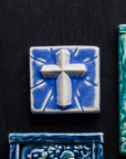 This Mario's Cross Tile features the matte bright steel blue Periwinkle Glaze.