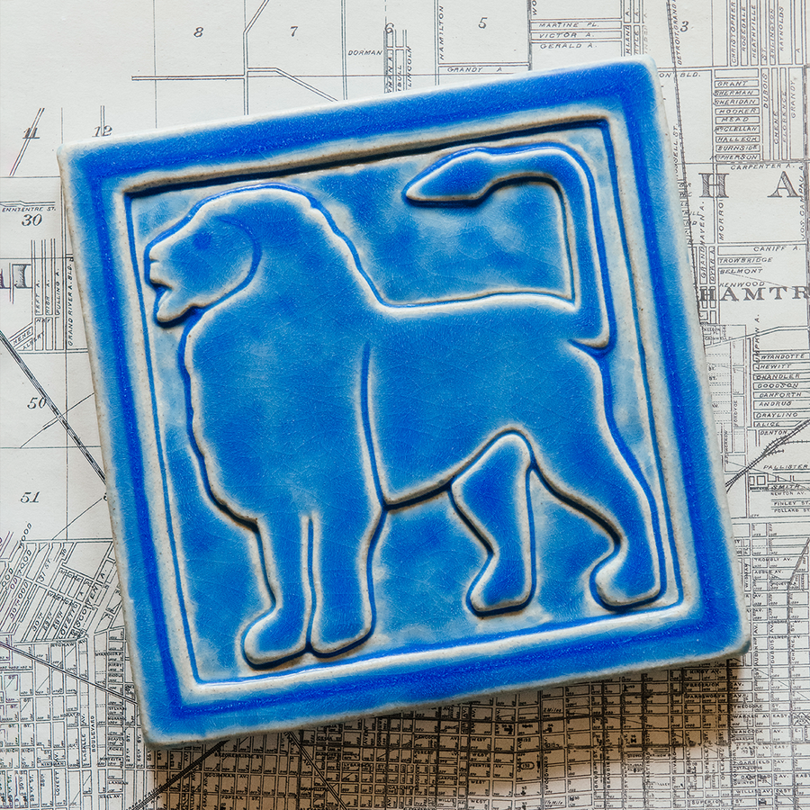 The right-facing Lion tile in the Sky glaze sits on a black and white map of Detroit.