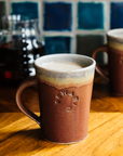 This Cafe Mug has a matte Cinnamon glaze with a gray colored interior.