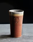 This Pint features the matte brownish-red tones of the Cinnamon glaze with a gray interior and lip.