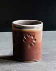 These Rocks cups feature the matte reddish-brown Cinnamon glaze. The inner lining and lip of the cup have a speckled gray.