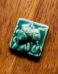 This 3x3 ceramic acorn tile is in the matte Pewabic green glaze option.