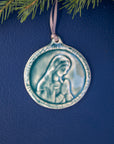 This ceramic Blessed Virgin Mary Ornament is glazed our calming, glossy, light-blue Glacier glaze with a delicate ribbon string in shimmering taupe.