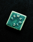 This tile features the matte blueish-green Pewabic Green glaze.