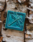 This Dragonfly Tile features the matte blueish-teal Pewabic Blue glaze.