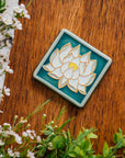 The Lotus tile features a line drawing of a blooming lotus flower, its pointed petals outstretching. It has a simple border around the design.