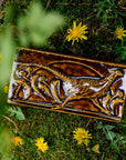 The long, horizontal Pheasant Tile features a male ring-necked pheasant running across the tiles. Puffy late-summer dandelions surround its outstretched feet. A large, domed sun is setting behind it. Featured in in a glossy brown Molasses glaze.