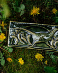 This hand-sculpted tile features a pheasant running through a field of dandelions. It is featured in a glossy green Kale glaze.