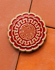 A Mooncake Paperweight in two-tone Scarlet/Honey.