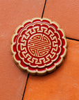 A Mooncake Paperweight in two-tone Scarlet/Honey.