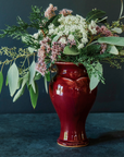 The Small Classic Vase starts with a small diameter at its base that gradually gets larger until it contracts again near the top with a slightly wider lip. The sides of the vase have been swiped with slip, this gives the appearance of abstract petals overlapping on the widest part of the vase.