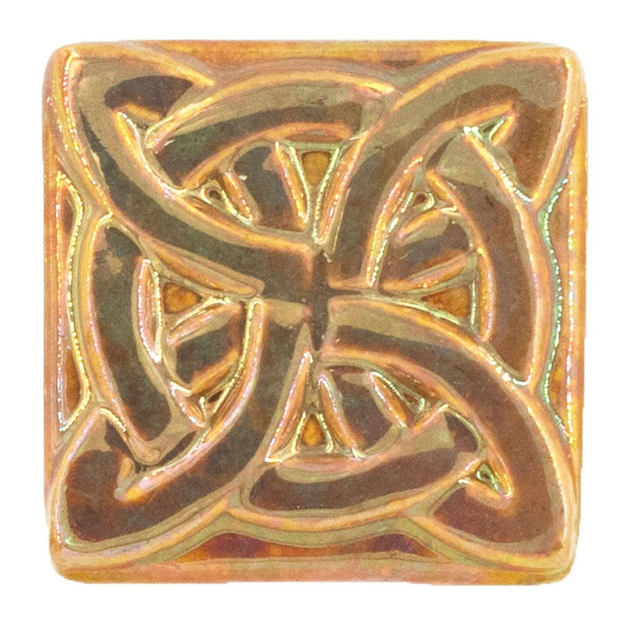 This Lover's Knot Tile features the pinkish gold metallic Blush Iridescent finish which has many variations. Depending on the lighting in the room, these pieces will pick up different hues.
