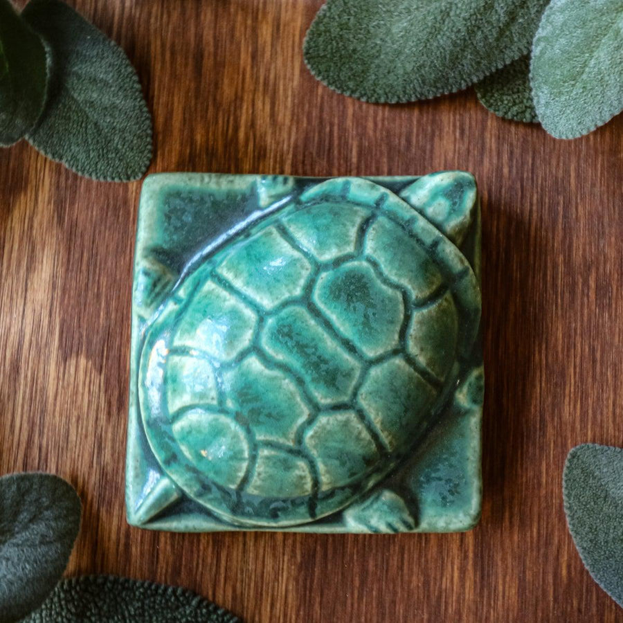 This paperweight features the matte blueish-green Pewabic Green glaze.