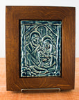 The Nativity Tile features the haloed holy family - Joseph, Mary and Baby Jesus - embracing under the wooden beams of the stable. Behind them, a window in the stone wall gives a glimpse of the Bethlehem star. This tile is in our glossy deep blue Ocean glaze which beautifully offsets the yellowish brown oak wood frame.