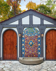 This installation is flat against what looks like a garage with two curved topped wooden doors on either side.