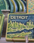 This two-tone Detroit Skyline tile is featured in the Lime/Lagoon color palette. The sky and water are in the matte blue Lagoon glaze and the skyline, boat, and word is in the matte bright light green Lime glaze.