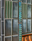 Detail photo of the tile texture. You can see the light reflecting off of the Gunmetal, Rain, and Aurora Iridescent glazed tiles.