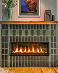 Straight on view of a custom Pewabic fireplace incorporating Midcentury Modern design elements with an Aurora Iridescent Saarinen-inspired tile border.