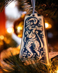 The Ceramic Eleven Pipers Piping Ornament is hanging on a Christmas tree.