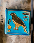 First designed in the 1920s, this hand-painted 3x3 tile depicts the bird hieroglyph Horus, the falcon-headed God of Light.